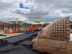 Photo of Farrow Riverside Miracle Park, including a giant baseball glove and playground equipment.